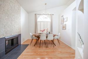 a dining room with a table and chairs and a fireplace at Stylish & Sunny With Heated Pool In The Foothills! in Phoenix