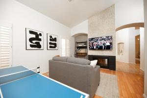 a living room with a couch and a table at Stylish & Sunny With Heated Pool In The Foothills! in Phoenix