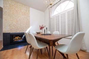 a dining room with a table and chairs and a fireplace at Stylish & Sunny With Heated Pool In The Foothills! in Phoenix