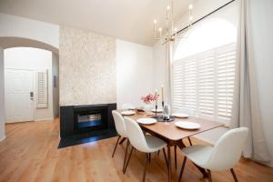 a dining room with a table and chairs and a fireplace at Stylish & Sunny With Heated Pool In The Foothills! in Phoenix