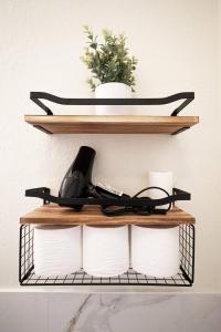 a shelf with a phone and some toilet paper at Stylish & Sunny With Heated Pool In The Foothills! in Phoenix