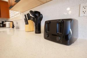 a black toaster sitting on a counter in a kitchen at Stylish & Sunny With Heated Pool In The Foothills! in Phoenix