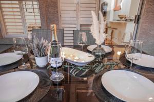 a dining room table with wine glasses on it at Stylish & Sunny With Heated Pool In The Foothills! in Phoenix