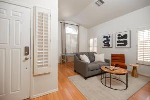 a living room with a couch and a table at Stylish & Sunny With Heated Pool In The Foothills! in Phoenix