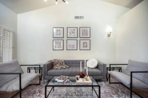 a living room with a couch and a table at Stylish & Sunny With Heated Pool In The Foothills! in Phoenix