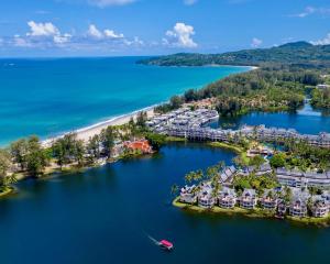an aerial view of a resort on an island in the water at 3BR Casa Azul - Beachfront Home in Laguna & Layan Chom Tawan and Maan Tawan Residences in Phuket Town
