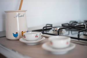 two cups sitting on a counter next to a stove at Villa Sofia in Taormina