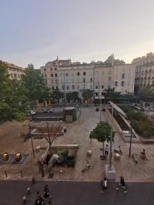 a group of people sitting in a courtyard in front of a building at Le Central Studio in Marseille
