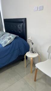 a bedroom with a bed and a table with a lamp at Torres Brickell Plaza. in Tigre +15 photos