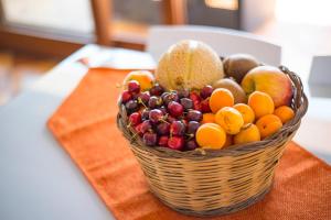 a basket of fruit sitting on a table at Villa Sofia in Taormina