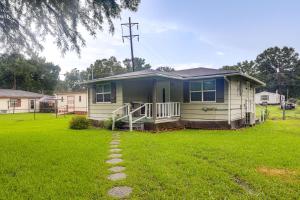 a small house in a yard with a green lawn at 14 Mi to Downtown Baton Rouge Plaquemine Retreat in Plaquemine