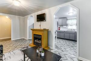 a living room with a fireplace and a kitchen at 14 Mi to Downtown Baton Rouge Plaquemine Retreat in Plaquemine