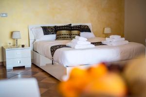 a bedroom with a bed with towels on it at Villa Sofia in Taormina