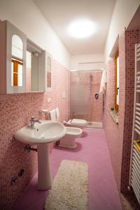 a bathroom with two toilets and a sink and a shower at Villa Sofia in Taormina +37 photos