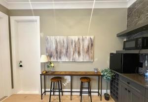 a kitchen with a table and two stools at Richmond Sweet home in Richmond