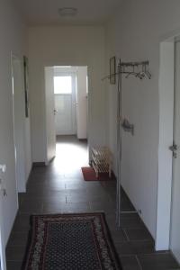 an empty hallway with a rug on the floor at Ruhige Ferienwohnungen mit Teichblick in Wetterfeld +25 photos