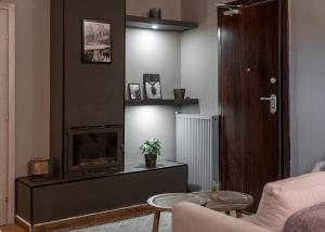 a living room with a fireplace and a couch at Leonidas by GM Luxury Suites Kalavryta in Kalavrita