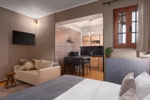 a bedroom with a bed and a living room at Leonidas by GM Luxury Suites Kalavryta in Kalavrita +13 photos