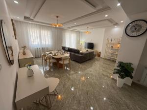 a living room with a table and a couch at Apartement haut standing in Constantine