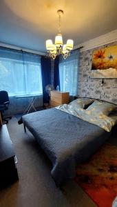 a bedroom with a large bed with a brick wall at 2 bedroom apartment metro Vasilkovskaya in Kyiv