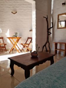 a living room with a coffee table and chairs at La Montaña B&B in Cafayate +24 photos