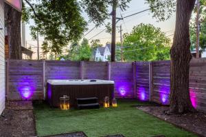 a backyard with a hot tub and purple lights at Electric Disco Den - 6 Min Walk to Rainey St in Austin +21 photos