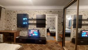 a living room with a tv and a bedroom at 2 bedroom apartment metro Vasilkovskaya in Kyiv