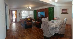 a living room with a table with chairs and a couch at WaskarWasi in Cusco