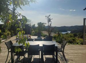 a table and chairs with a view of a lake at Villa Varden 10 min from Bergen sentrum in Bergen