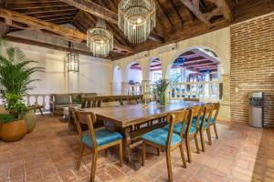 a dining room with a wooden table and chairs at Casa D Boutique in Cartagena de Indias