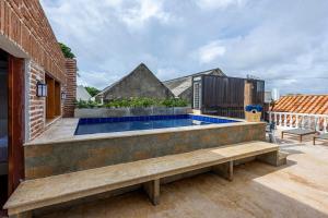 a backyard with a swimming pool and a brick building at Casa D Boutique in Cartagena de Indias