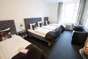 Postel nebo postele na pokoji v ubytování Hotel Vinhuset