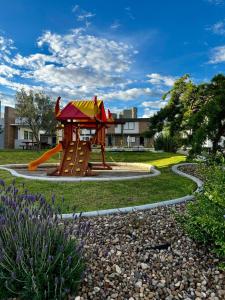 a playground with a slide in a park at New Bamboo City Views in Cedro