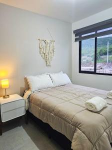 a bedroom with a bed and a window at New Bamboo City Views in Cedro