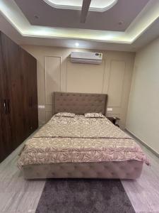 a bedroom with a large bed in a room at Beauty Living in Kharar +3 photos