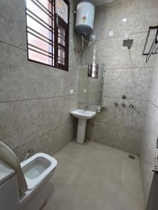 a bathroom with a sink and a toilet and a shower at Beauty Living in Kharar