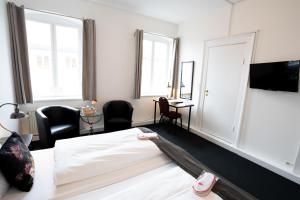 TV a/nebo společenská místnost v ubytování Hotel Vinhuset