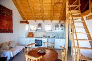 a kitchen and dining room with a wooden table and chairs at Holiday house with a swimming pool Gromin Dolac, Hvar - 24689 in Jelsa