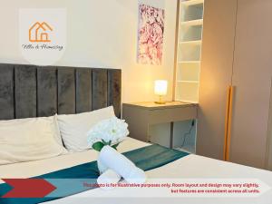 a bedroom with a bed with a vase of flowers on it at Cozy unit- Bell suites- Horizon Suites- Wifi- Netflix- Parking Swimming Pool- Klia in Sepang +100 photos