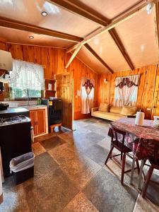 a kitchen with a table and a couch in a room at Casa de campo Ecos del Poás in Alajuela +12 photos