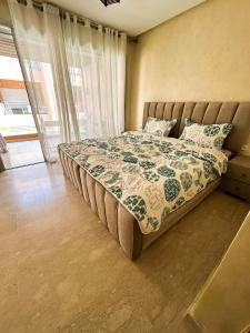 a large bed in a bedroom with a window at Bleu pearl imi ouaddar in Agadir