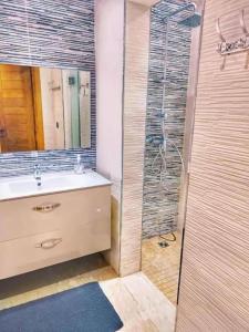 a bathroom with a sink and a shower at Bleu pearl imi ouaddar in Agadir