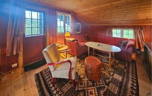 a living room with a couch and a table at Amazing Home In Eggedal With Sauna in Eggedal