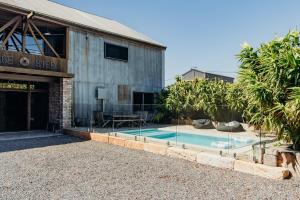 a house with a swimming pool next to a building at VintageSteel Hinton in Hinton