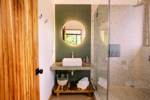 a bathroom with a sink and a shower at MAUMA Forest Villas - Fireplace & Amazing Views in Monteverde Costa Rica