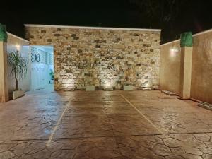 a room with a stone wall and a stone floor at Chan Kiin Departamentos in Valladolid +7 photos