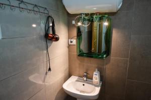 a small bathroom with a sink and a mirror at Dikellari Guest House in Pogradec +36 photos