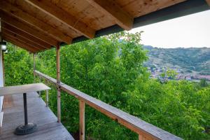 a porch of a house with a view of trees at Dikellari Guest House in Pogradec