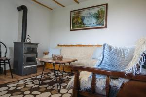 a living room with a couch and a table at Dikellari Guest House in Pogradec