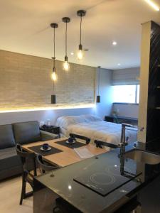 a living room with a bed and a table at International Airport Flat in Guarulhos